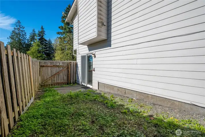 fenced side yard off downstairs family room perfect for pets