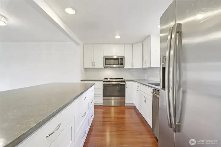 Kitchen has a fresh feel with lots of cabinetry & counterspace