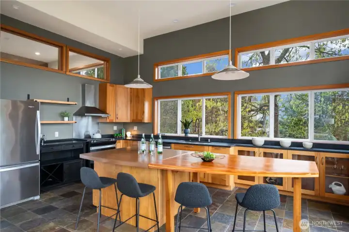 Kitchen with cherry cabinets, stainless appliances, quartz and concrete counters