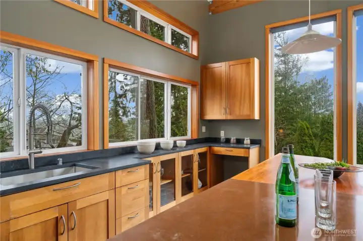 Kitchen with cherry cabinets, stainless appliances, quartz and concrete counters