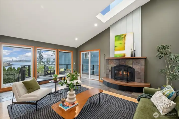 Living room with vaulted ceilings, skylights and lake views