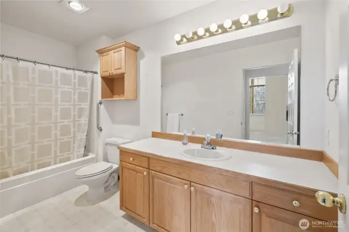 Spacious bath with tub/shower and full sized vanity.
