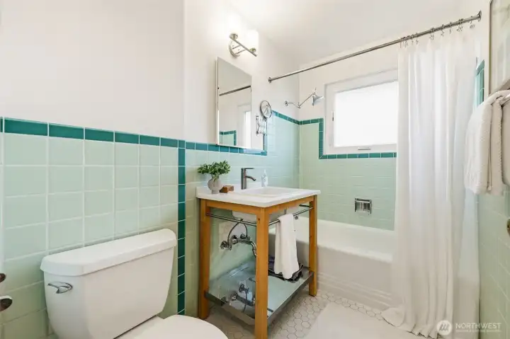 Full bathroom boasts vintage wall tiles - in great condition.  The bathtub has a newer tub/shower value and was just re-glazed with a non-slip material applied to the floor of the tub.