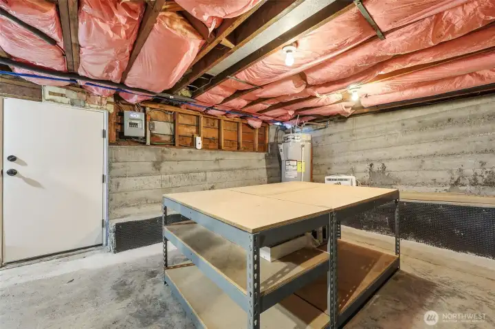 ...and a work table with storage below.  Hot water heater was installed in 2022.  An extensive drainage project was completed in 2025 to ensure a dry basement. See more details in list of updates.