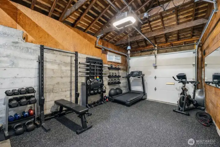 Sellers used the garage as a home gym.  Floor tiles to stay (can easily be removed for parking).  Photo is virtually staged.