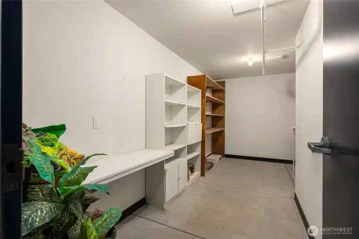This storage room is one of the largest with space for a work bench to the right.
