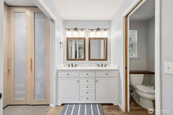 A luxurious en-suite bathroom featuring a dual sink vanity, perfect for convenience and style.