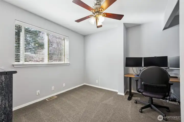 A bright and versatile bedroom ideal for guests, family, or a home office.