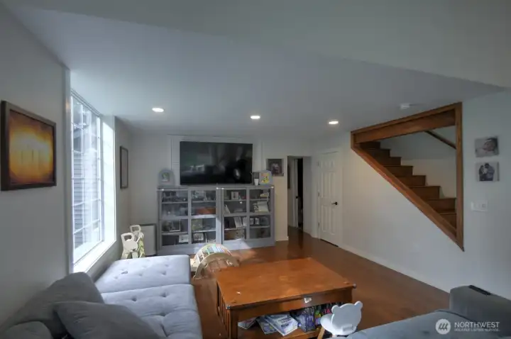 Living room with a peek-a-boo cut out of the stairs