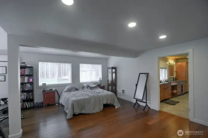 Primary bedroom is spacious with so much natural light