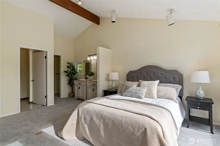 Vaulted ceilings in spacious open primary with include 3/4 bath and huge walk in closet.
