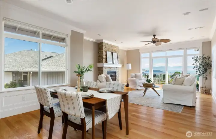 Hardwood floors, Hunter Douglas blinds, and ceiling fans throughout create a warm and comfortable living environment