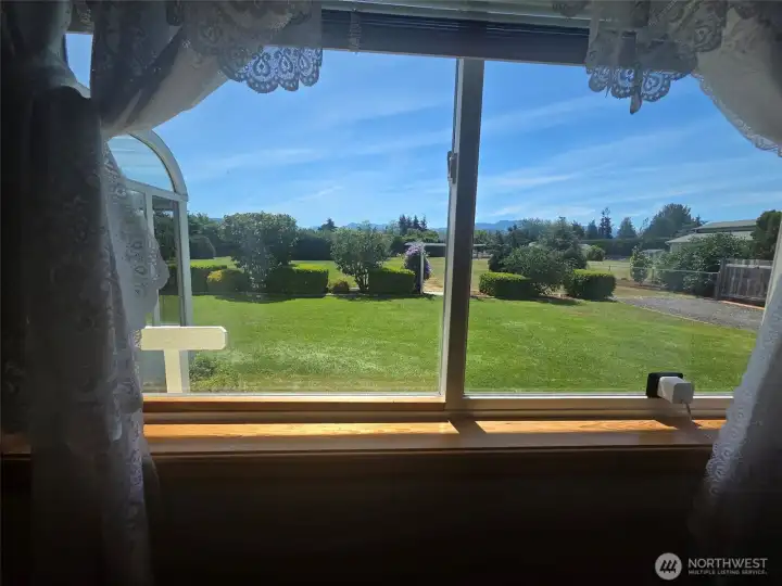 Primary bedroom enjoys serene mountain views, lush landscaping, and a private backyard setting.