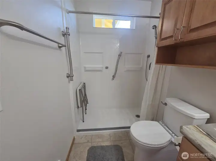 Zero-entry shower with attached shower chair adds comfort, accessibility, and peace of mind. Removable toilet safety handles are also available for additional support.