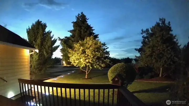 Sunset caught by security camera with the solar-powered driveway lights providing a path.