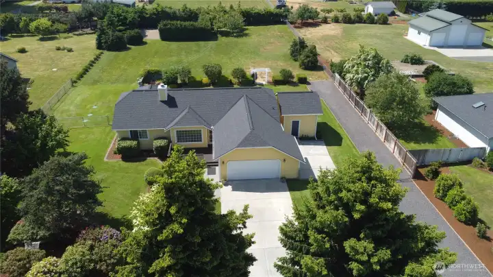 Exceptional aerial perspective highlights the property's spacious layout, manicured grounds, fenced backyard, and abundant outdoor living space.