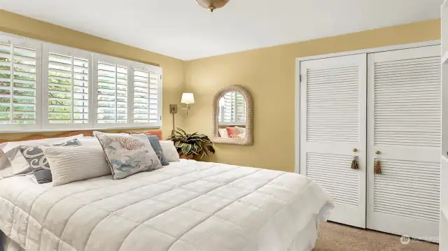 This is guest bedroom #1. Custom plantation wood shutters adorn all of the windows in the bedrooms.