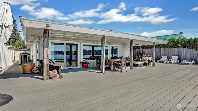 The covered area is perfect for entertaining guests. There's definitely room for everyone here. Large view windows take in all of the Hood Canal sites.