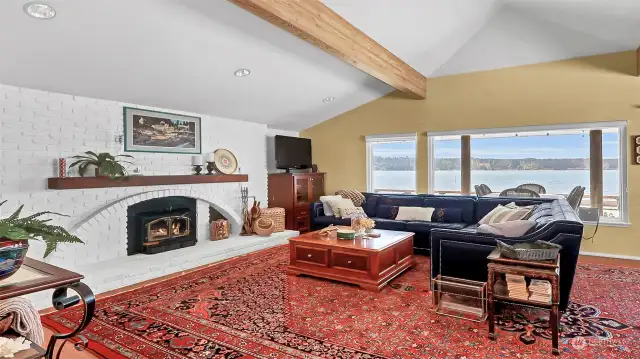 Large open living room. All of the furniture comes with the sale (except this huge rug). Look out the large view windows into the ever changing scenery of the Hood Canal.