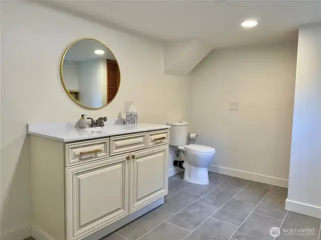 Half bath that also serves as laundry. Heated floors.