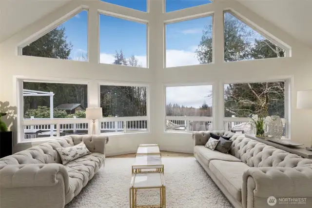 Soaring ceilings with a wall of windows to capture the nature outside.