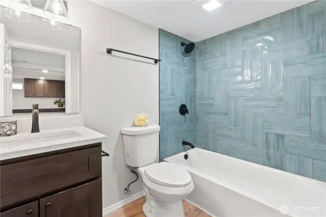Lower Level Full Bath w/Custom Tile Shower Surround, New Laminate Flooring and New Vanity, Fixtures.