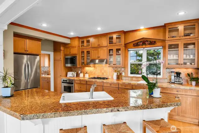 This amazing kitchen has beautiful, custom cabinetry with plenty of room for your dishes, linens and pretty treasures. Note the large counter for guests to gather.