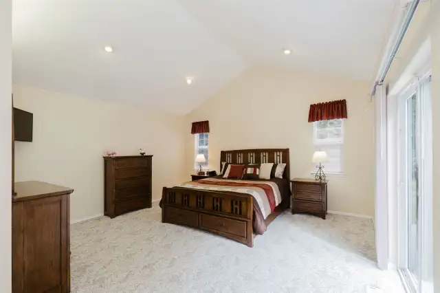 Massive Primary Suite with vaulted ceilings, and plenty of natural light.