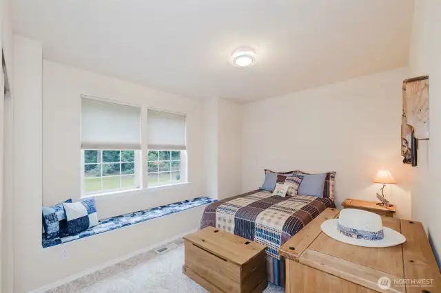 Guest bedroom with cozy window seat.