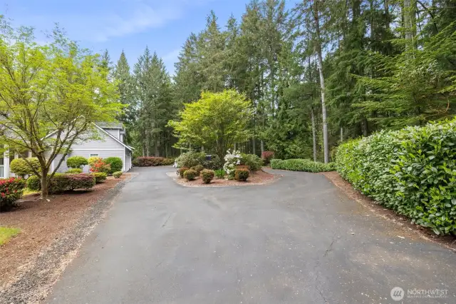 Black top circular drive leads you to the 5 car garage and 2 covered RV/boat parking.