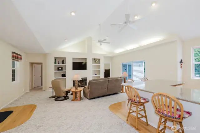 As you enter the front door, you are welcomed in to a massive open concept living/dining/kitchen with soaring vaulted ceilings and windows in all directions.