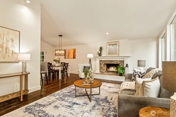 Stone hearth and custom fireplace surround highlight the welcoming living room.