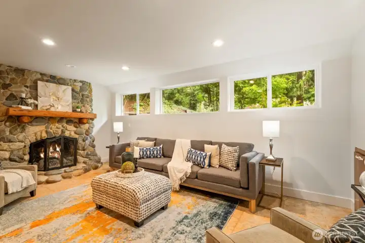 Downstairs family room with stone fireplace and inviting views.