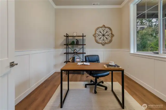 Main floor office/den off the entry area creates a home office that is easily accessible to the residents and guests
