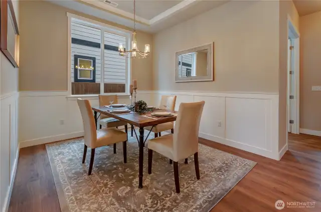 Dedicated formal dining area with wainscoat, coved ceiling and ample light make this room perfect for entertaining