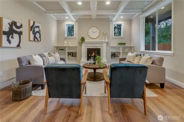 A great room like none other! Hardwood flooring, custom white painted mantle complimenting the natural gas fireplace with bookshelves plus a hand-crafted box beam ceiling.