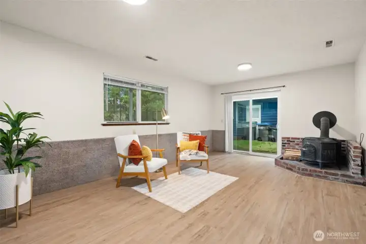 Flexible lower level room features new sliding door to backyard.