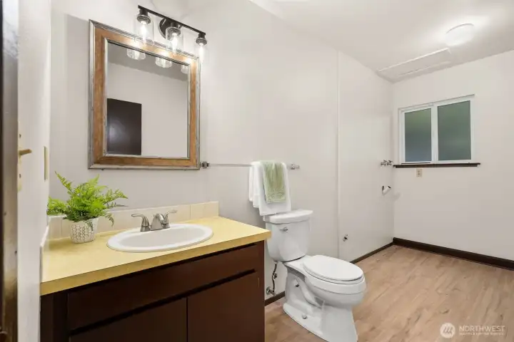Roomy and convenient lower level laundry and half bath.