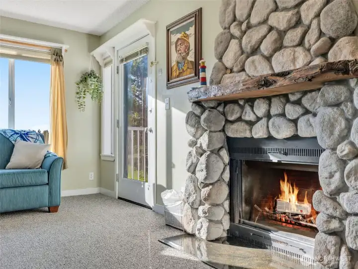 Gorgeous custom river-rock fireplace with cedar driftwood mantel.
