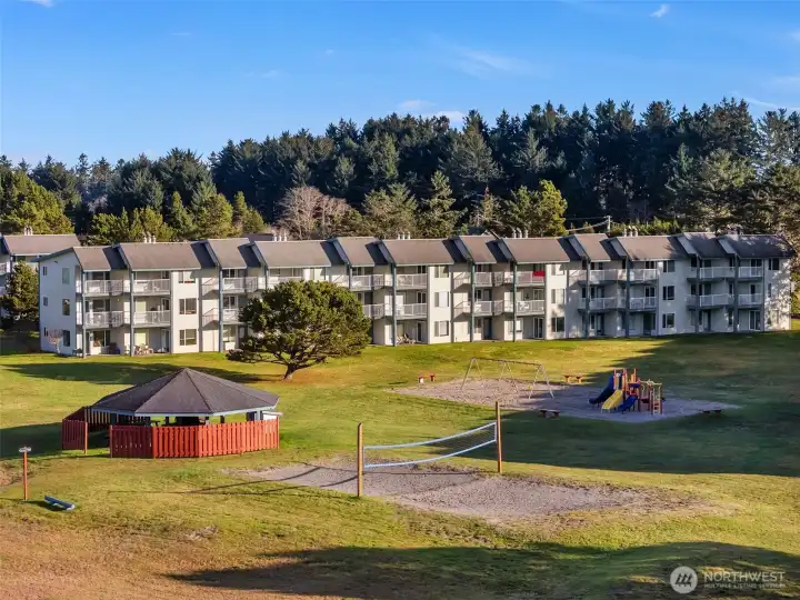 Community gazebo with BBQ, beach volleyball court, and playground.