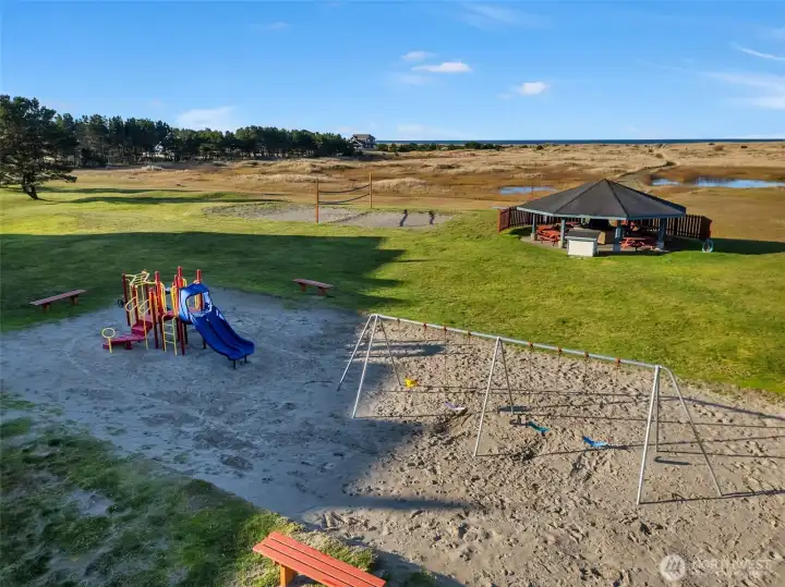 Community gazebo with BBQ, beach volleyball court, and playground.