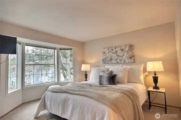 The primary bedroom is spacious with a bay window to the east.
