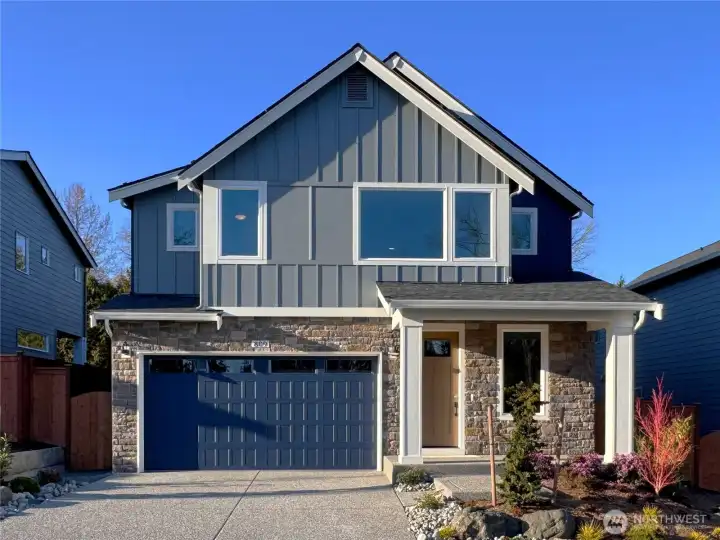 Exterior | Homesite 2  The Robinson plan on the south-facing homesite 2 showcases clean Pacific Northwest contemporary lines with a balanced mix of vertical siding and stone accents. Large upper-level windows introduce natural light while the covered entry creates a defined and welcoming approach. The streamlined façade reflects the architectural character associated with modern luxury new construction.    Located in Bothell’s Canyon Park neighborhood, this thoughtfully designed home is currently under construction. Garage and front door colors are subject to change as finishes are finalized. The residence reflects the quality and craftsmanship expected in new construction homes served by the Northshore School District.    All photos, renderings, site maps, and floorplans are for visualization purposes only.