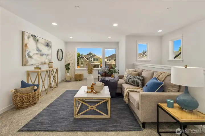 Upstairs Bonus Loft  This open upstairs bonus loft provides flexible living space with expansive windows that bring in natural light and frame neighborhood views. Soft carpeting and recessed lighting create a comfortable setting for a media room, secondary lounge, or play area. The open layout maintains connection while offering separation from the main level.    Situated in Bothell’s Canyon Park neighborhood, this versatile loft reflects the thoughtful design associated with high-quality new construction. The adaptable upper-level space supports modern living within a contemporary home located in the Northshore School District.    These photos are from a past Robinson Plan at a different community, so overall plan, colors, building orientation, finishes, home outlook, and other details can and WILL vary. All photos, renderings, site maps, and floorplans are for visualization purposes only.