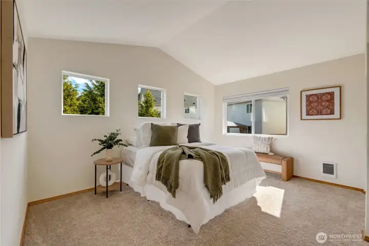 Large Primary Bedroom with vaulted ceilings and an abundance of windows for natural light