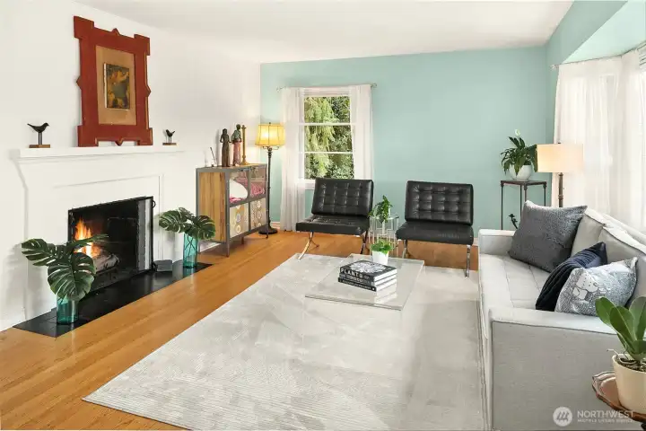 This main level living room features a cozy gas fireplace and a large bay window that takes full advantage of the views.