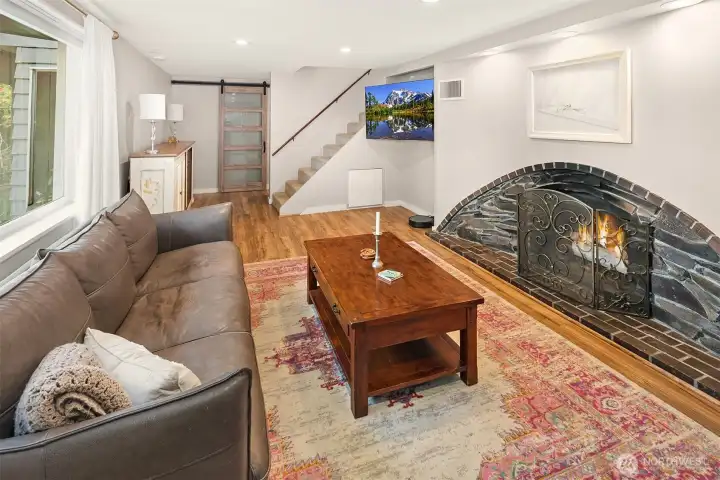 The lower level living area is graced with this gorgeous arched cove-style fireplace with gas insert.