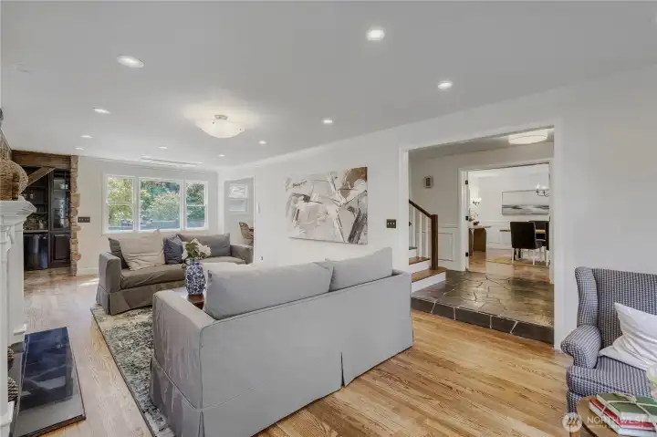 Step into the living room with is sparkling floors, formal fireplace and rustic bar, an homage to the home's great history. Views to the lake and to the expansive backyard.