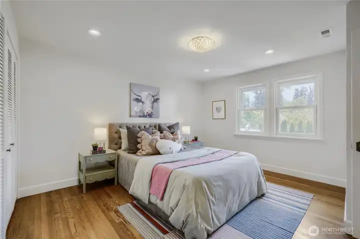 Here is the NE bedroom with it's fresh floors and view of the golf course and backyard.