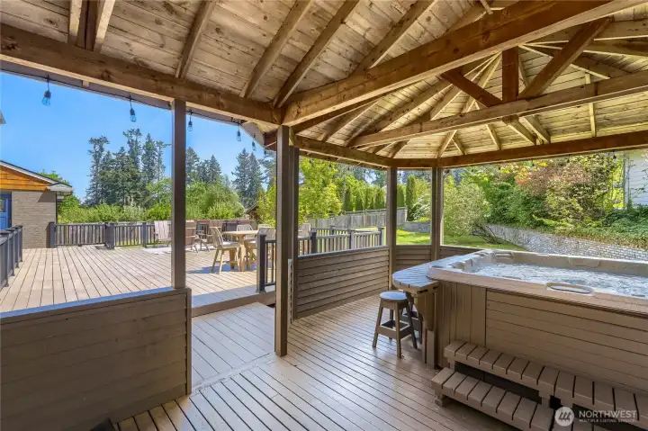 The huge covered deck space protects the fabulous hot tub with shelter and keeps your BBQ out of the rain.